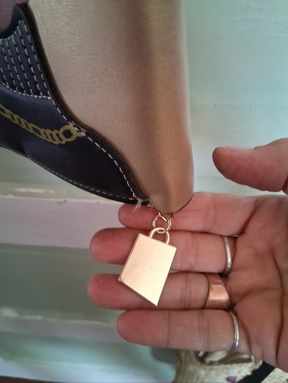 Fashionable Gold Crossbody Bag with Graphic Face Design